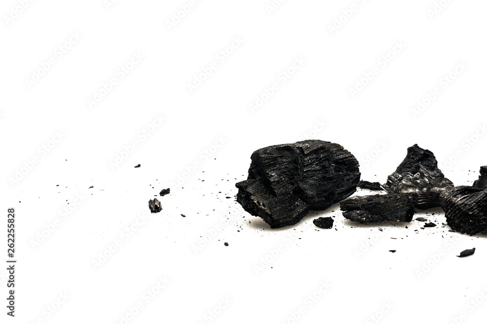 Black burnt firewood with ash on white surface Black burnt firewood with ash on white surface