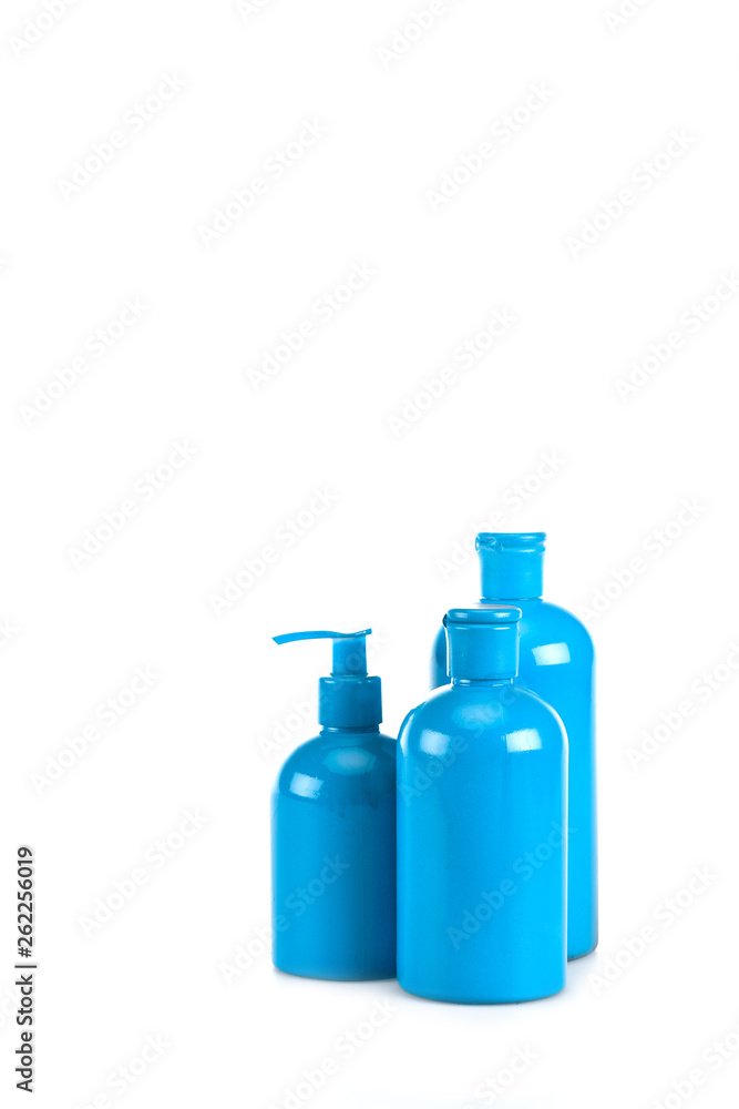 Blue cosmetic bottles with spray and caps on white Blue cosmetic bottles with spray and caps on white