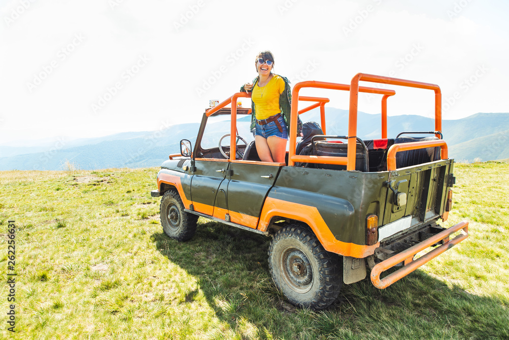happy laughing woman on suv car in mountains happy laughing woman on suv car in mountains