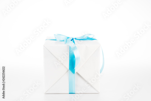 White gift box with blue ribbon on white