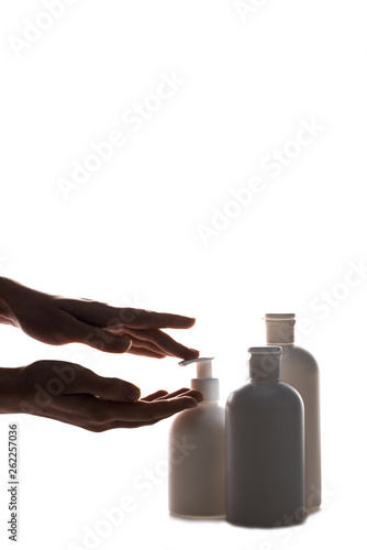 Cropped view of woman applying hand cream isolated on white