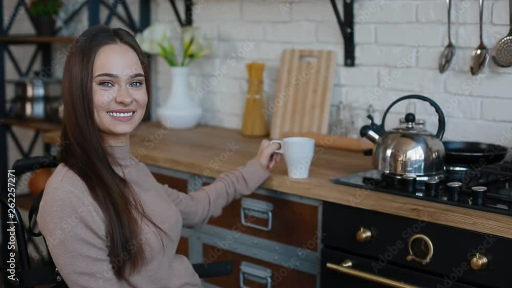 Smiling disabled woman on the kitchen Smiling disabled woman on the kitchen