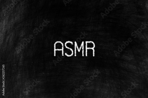 ASMR or Autonomous Sensory Meridian in Chalk Writing on Old Grunge Chalkboard Background.