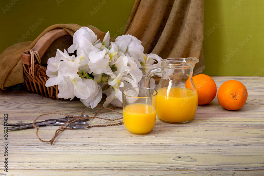 Still life with white irises and orange juice