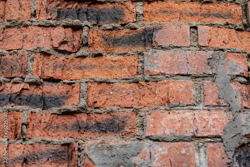 Old brick wall with cracks and scratches , background, texture 