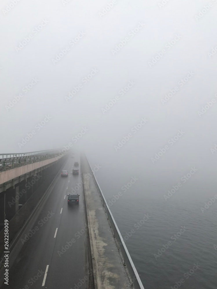 view on the bridge under the fog