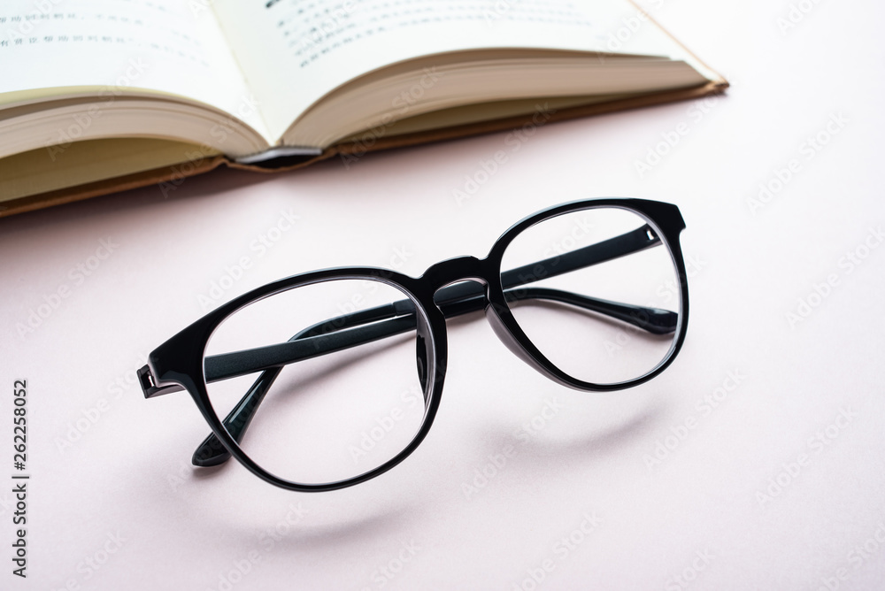 Glasses and book reading background material Glasses and book reading background material