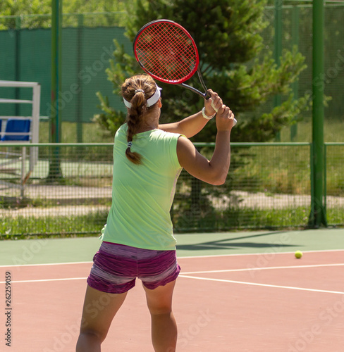 Girl playing tennis on the court © schankz