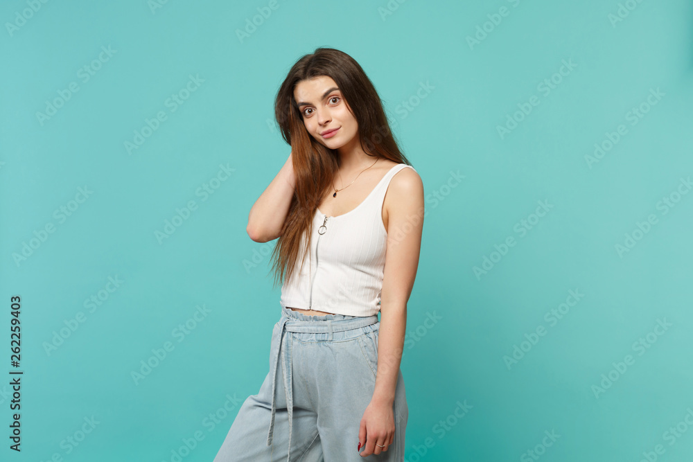 Portrait of amazed smiling young woman in light casual clothes looking camera putting hand on head isolated on blue turquoise background. People sincere emotions lifestyle concept. Mock up copy space. Portrait of amazed smiling young woman in light casual clothes looking camera putting hand on head isolated on blue turquoise background. People sincere emotions lifestyle concept. Mock up copy space.