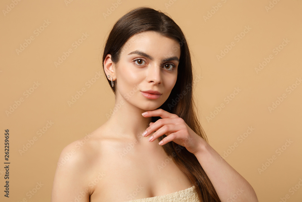 Close up brunette half naked woman 20s with perfect skin, nude make up isolated on beige pastel wall background, studio portrait. Skin care healthcare cosmetic procedures concept. Mock up copy space. Close up brunette half naked woman 20s with perfect skin, nude make up isolated on beige pastel wall background, studio portrait. Skin care healthcare cosmetic procedures concept. Mock up copy space.