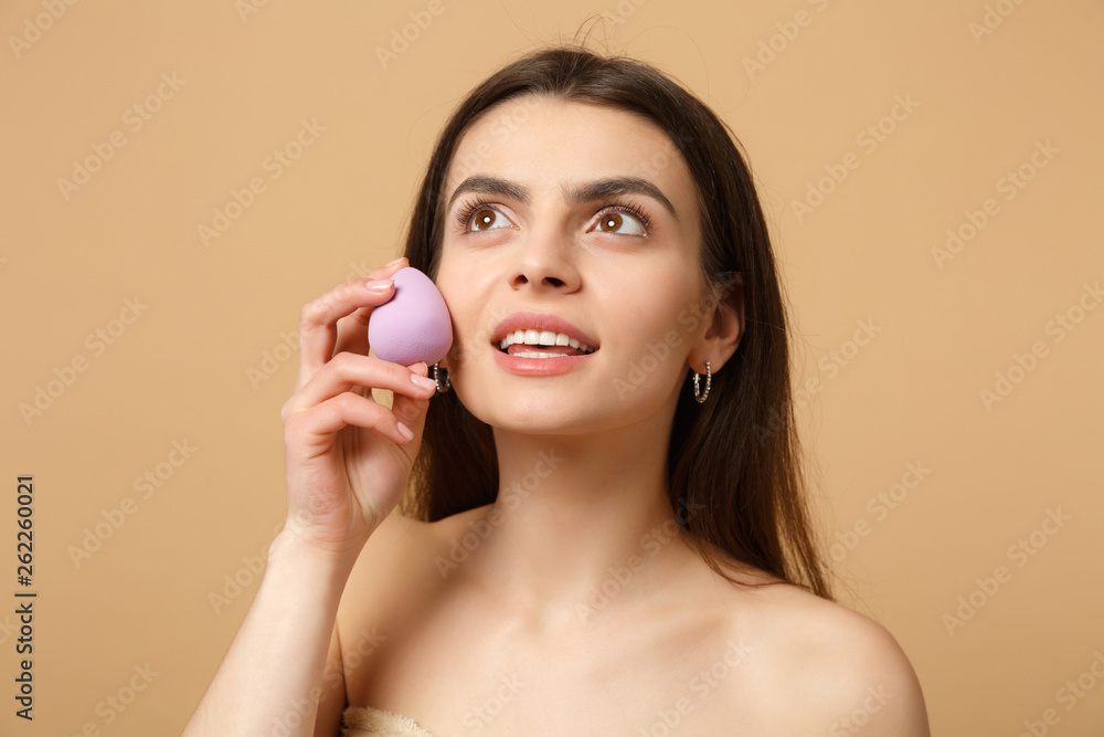 Close up brunette half naked woman 20s with perfect skin, nude make up isolated on beige pastel wall background, studio portrait. Skin care healthcare cosmetic procedures concept. Mock up copy space. Close up brunette half naked woman 20s with perfect skin, nude make up isolated on beige pastel wall background, studio portrait. Skin care healthcare cosmetic procedures concept. Mock up copy space.