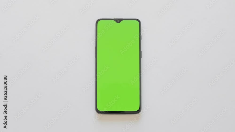 Green Screen - A modern smartphone lies on white background Green Screen - A modern smartphone lies on white background
