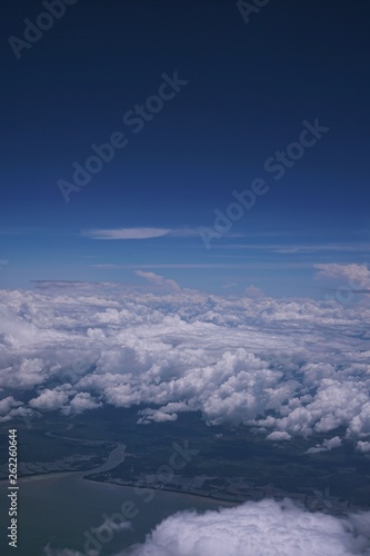 View of the sky and the blue sea from the plane's window