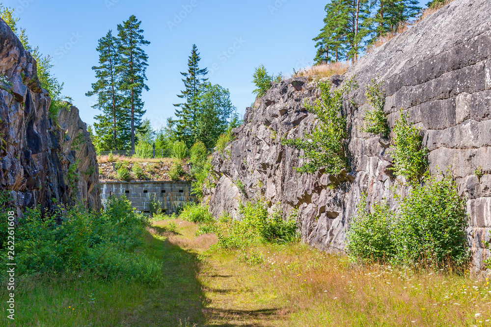 Moat blasted into the rock with loopholes for defense Moat blasted into the rock with loopholes for defense