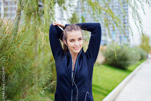 Sporty and active woman runner is listening to music