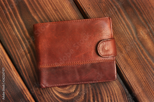 Leather wallet on a wooden background.