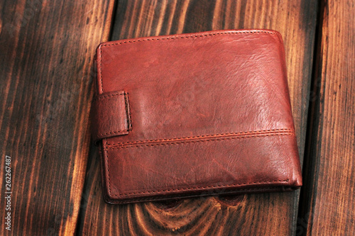 Leather wallet on a wooden background.
