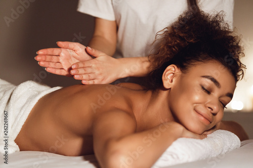 African-american woman getting spa treatment in healthy center