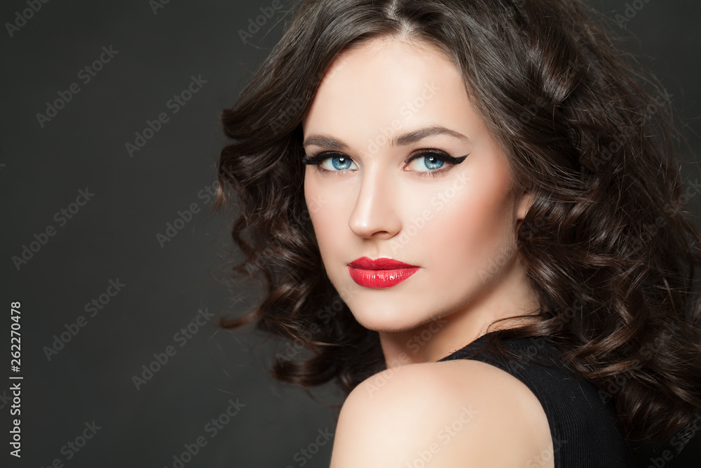 Fototapeta premium Beautiful woman with makeup and dark curly hair portrait