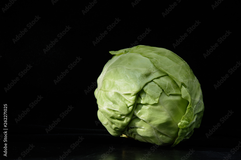 head of cabbage on a black background. Concept - cabbage diet head of cabbage on a black background. Concept - cabbage diet