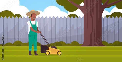 man gardener cutting green grass with lawn mover african american farmer moving garden backyard gardening concept flat full length horizontal