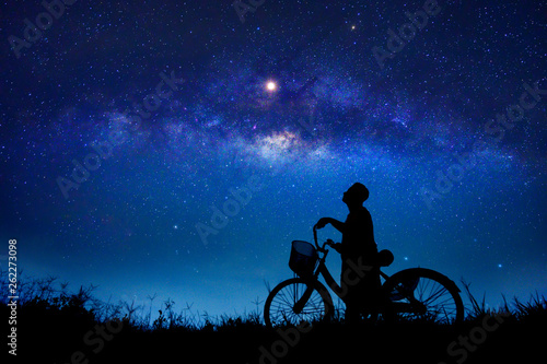 The boy is cycling in the midst of the stars galaxy