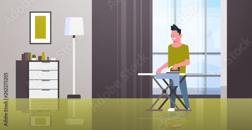 man ironing clothes guy holding iron doing housework housekeeping concept modern house living room interior male cartoon character full length flat horizontal
