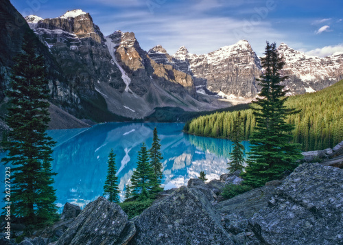 Mountains at sunrise rise above Moraine Lake in the Valley of the Ten Peaks, Banff National Park, Canada