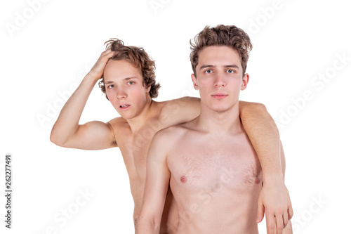 Two young sexy guys hugs on a white background. Love, passion and relationships