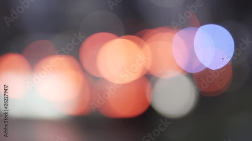 Abstract bokeh balls which show out of focus cars on a street with different colours and lights