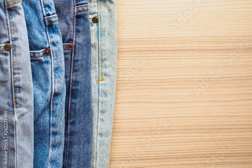denim blue jeans stack on wood table background