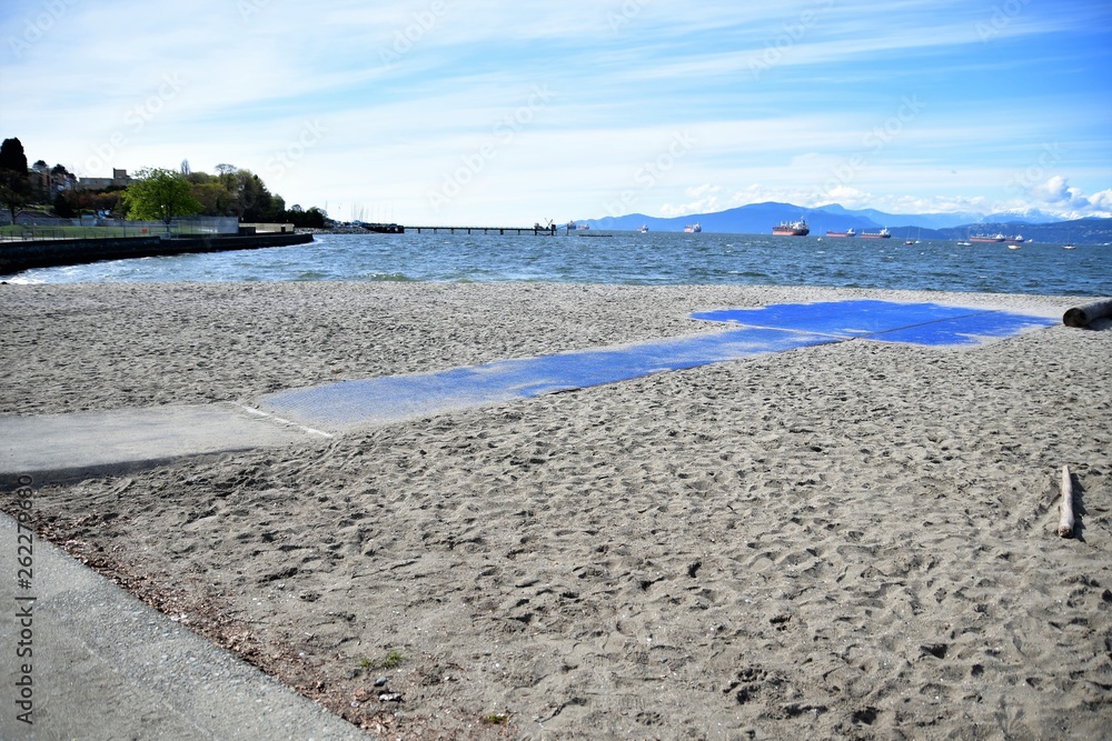 Obraz premium Mobi-Mats The wheelchair accessible mat on the beach. The non-slip pathways let people using walkers, wheelchairs, and scooters enjoy the total beach experience with friends and family. Mobi-Mats,mobi