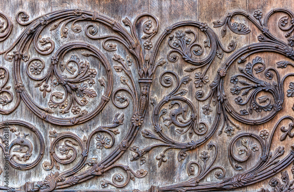 Detail of ornamental wood carving applied at the gates of Notre-Dame Cathedral - Paris, France