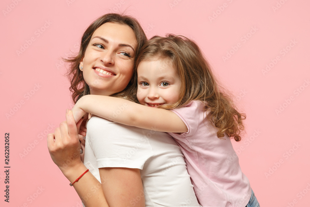 Woman in light clothes have fun with cute child baby girl. Mother, little kid daughter isolated on pastel pink wall background, studio portrait. Mother's Day, love family, parenthood childhood concept Woman in light clothes have fun with cute child baby girl. Mother, little kid daughter isolated on pastel pink wall background, studio portrait. Mother's Day, love family, parenthood childhood concept