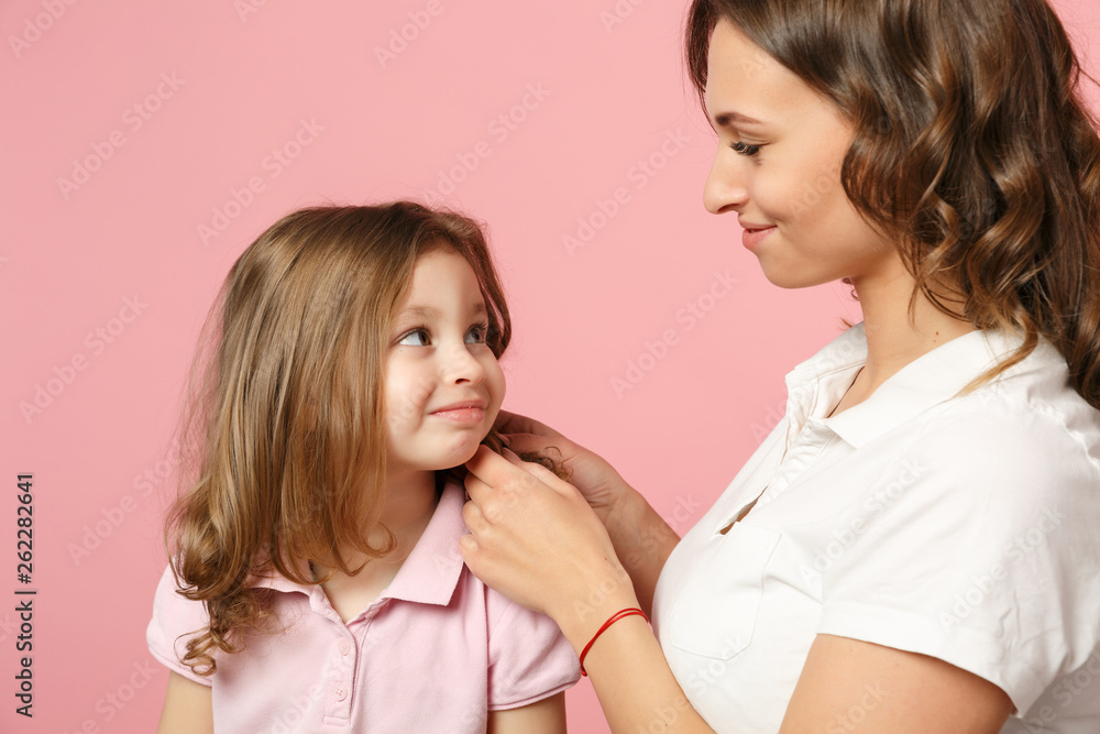 Woman in light clothes have fun with cute child baby girl. Mother, little kid daughter isolated on pastel pink wall background, studio portrait. Mother's Day, love family, parenthood childhood concept Woman in light clothes have fun with cute child baby girl. Mother, little kid daughter isolated on pastel pink wall background, studio portrait. Mother's Day, love family, parenthood childhood concept