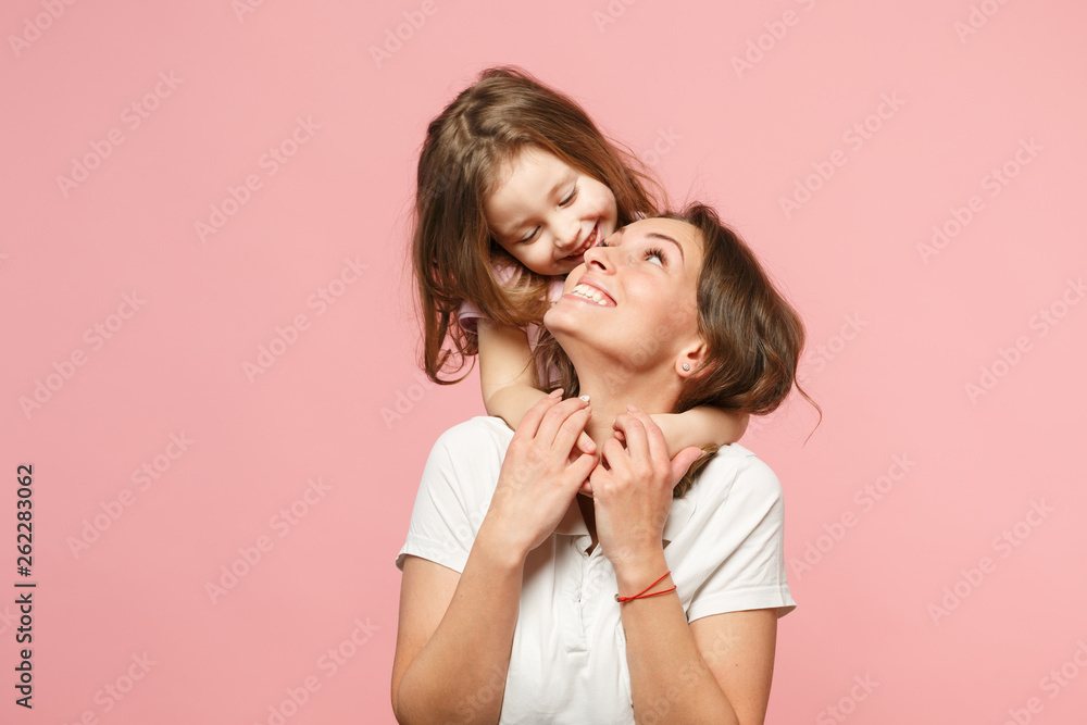 Woman in light clothes have fun with cute child baby girl. Mother, little kid daughter isolated on pastel pink wall background, studio portrait. Mother's Day, love family, parenthood childhood concept - obrazy, fototapety, plakaty 