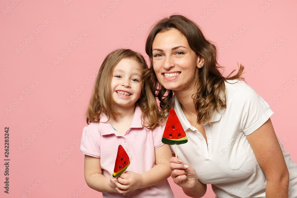 Woman in light clothes have fun with cute child baby girl. Mother, little kid daughter isolated on pastel pink wall background, studio portrait. Mother's Day, love family, parenthood childhood concept Woman in light clothes have fun with cute child baby girl. Mother, little kid daughter isolated on pastel pink wall background, studio portrait. Mother's Day, love family, parenthood childhood concept