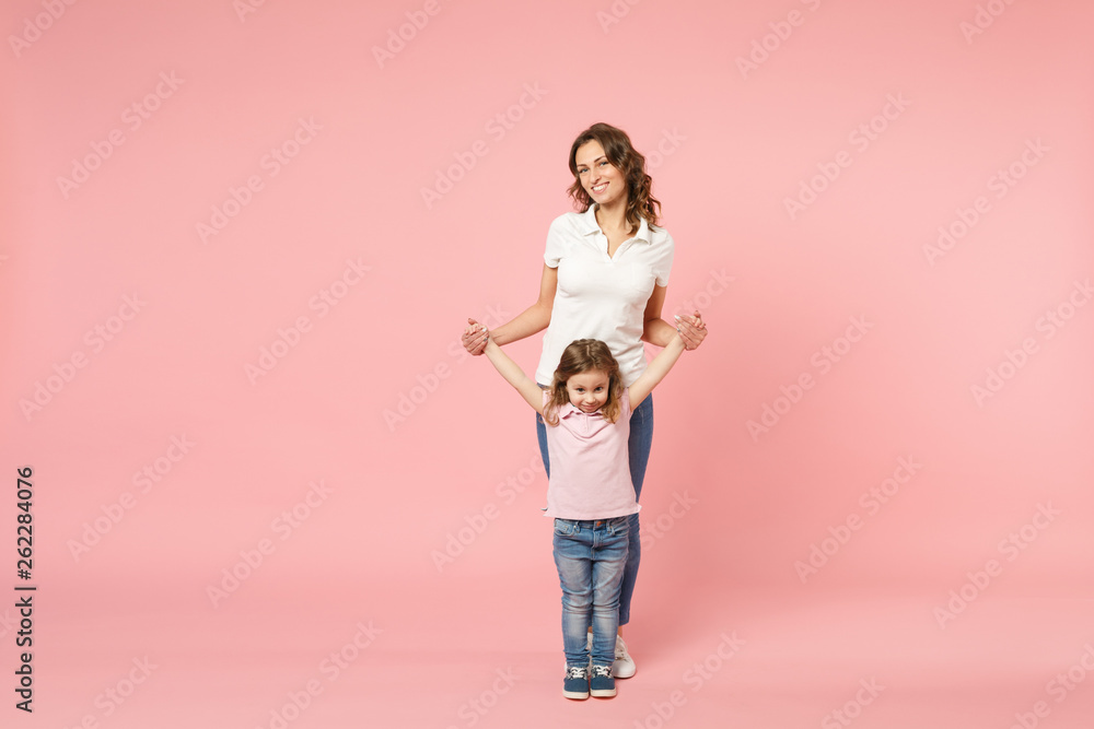 Woman in light clothes have fun with cute child baby girl. Mother, little kid daughter isolated on pastel pink wall background, studio portrait. Mother's Day, love family, parenthood childhood concept Woman in light clothes have fun with cute child baby girl. Mother, little kid daughter isolated on pastel pink wall background, studio portrait. Mother's Day, love family, parenthood childhood concept