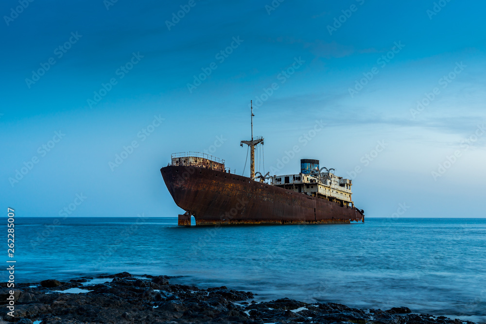 Spain, Lanzarote, Wreck of temple hall boat stranded at coast of arrecife in blue hour Spain, Lanzarote, Wreck of temple hall boat stranded at coast of arrecife in blue hour