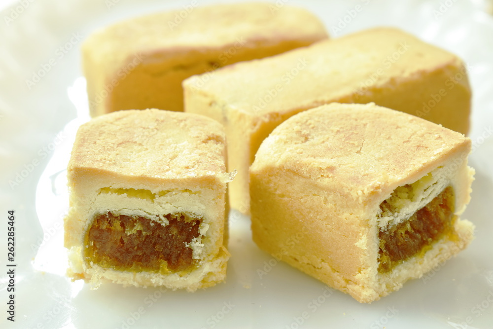 indigenous pineapple cake half cut on plate indigenous pineapple cake half cut on plate