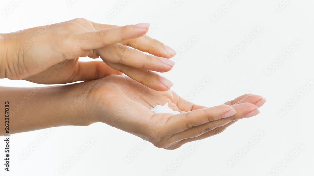Skin care. Woman applying moisturizing cream to her hands