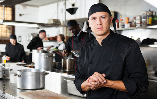 Fototapeta Naklejka Na Ścianę i Meble -  Confident male chef posing at restaurant kitchen