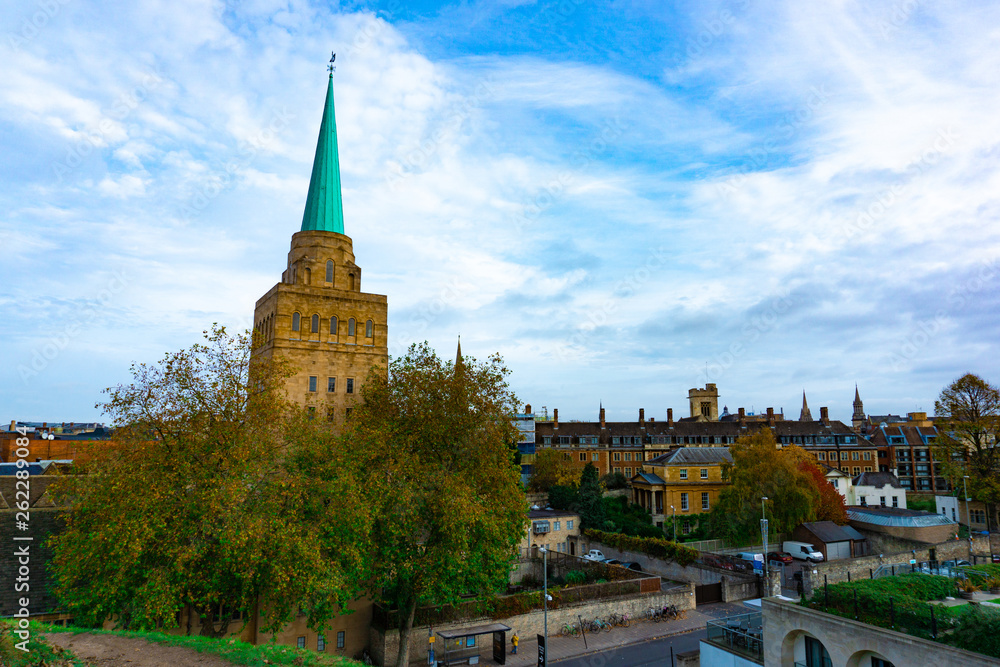 Naklejka premium Aerial view of Oxford with the Spire of Nuffield College in cloudy blue sky day