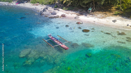 Traditional boat with Beautiful nature of blue sea sand and Turquoise color water waves at Atauro Island, Timor Leste photo