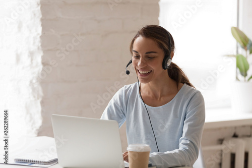 Beautiful smiling woman man working in headphones at office photo