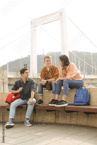 Photography Friends chatting, sitting on a bench