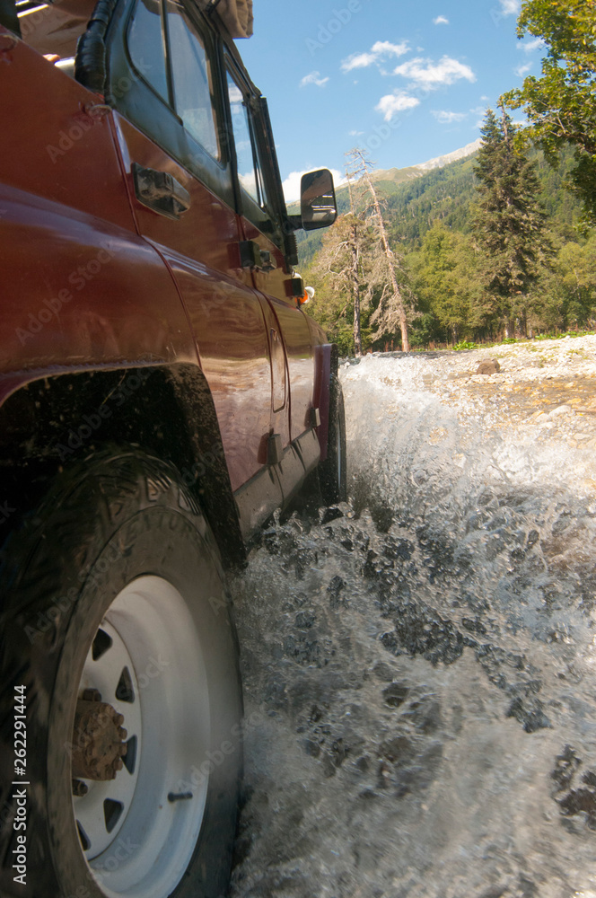 Suv offroad 4wd car rides through muddy puddle, off-road track road, with a big splash. Suv offroad 4wd car rides through muddy puddle, off-road track road, with a big splash.
