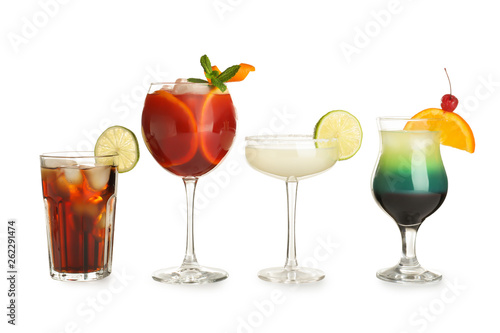 Glasses of traditional alcoholic cocktails on white background