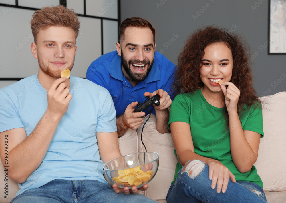 Emotional friends playing video games at home Emotional friends playing video games at home