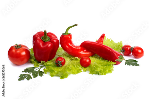 Red sweet long pepper and tomato on a white background. Red bell pepper with garlic on a white background. Red peppers with tomatoes and garlic on a white background.